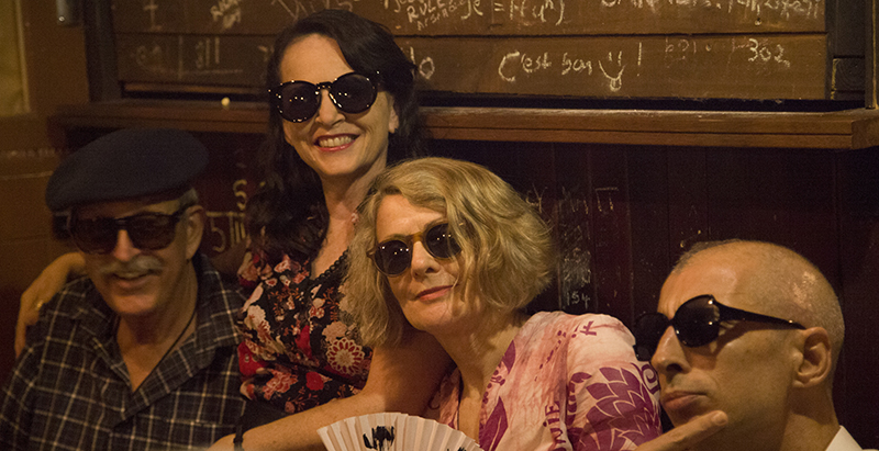 a photograph of poets in sunnies in a basement (left to right: Tom, Shanti, Pam, Matt)