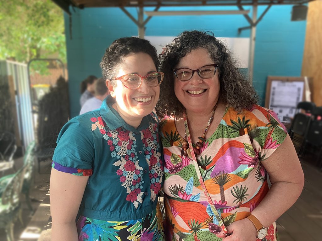 Anna and her Mum, sari, smiling in brightly coloured clothing.
